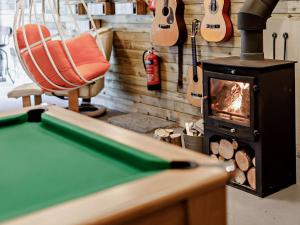 a pool table with a wood stove in a room at 2 Bed in Bovey Tracey PRIMC in Hennock