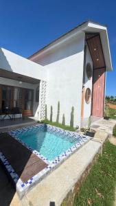 a swimming pool in front of a house at Umacabana 2 in Dieng