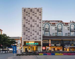 a tall building in the middle of a street at City Comfort Inn Hotel Dongguan Humen Pedestrian Street in Dongguan