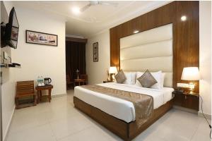 a bedroom with a large bed in a hotel room at Hotel Luck Recdancy mahipalpur in New Delhi