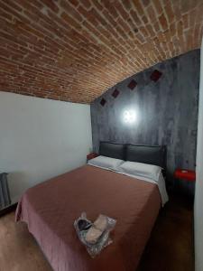 a bedroom with a bed with a brick wall at Ladyemma in Turin