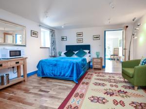 a bedroom with a blue bed and a living room at 4 Bed in Newtown 48641 in Kerry