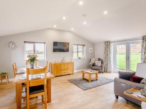 a living room with a table and a couch at 2 bed property in Stanton-By-Bridge 78582 in Chellaston