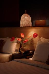 a bedroom with a bed with red flowers on it at Asian Ruby Hotel & Spa - 122F Bui Thi Xuân Street in Ho Chi Minh City