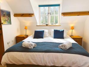 a bedroom with a large bed with towels on it at 3 Bed in Bucks Mills OLDSB in Bucks Mills
