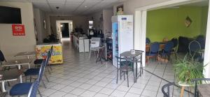 a restaurant with chairs and tables in a room at Pension Stechlinsee in Neuglobsow