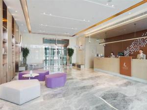 a large lobby with purple chairs and a counter at Lavande Hotel Shanghai Jing'an Shibei Gaoxin in Shanghai