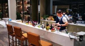 a woman standing at a bar in a restaurant at Lavande Hotel Shanghai Jing'an Shibei Gaoxin in Shanghai