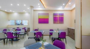 a dining room with purple and white chairs and tables at Lavande Hotel Changsha West Jiefang Road Furong Plaza in Changsha