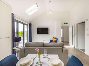 a living room with a couch and a table and chairs at 1 Bed in Bude 87977 in Stratton