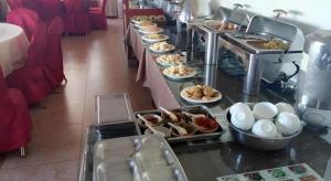 a buffet line with many plates of food at Green Tree Inn Urumqi San'gong Metro Station Exit in Ürümqi