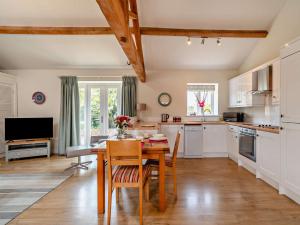 a kitchen with a wooden table and a dining room at 1 Bed in Hilton 76518 in Tutbury