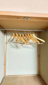 a rack of wooden cooking utensils on a shelf at 苗場ウッドインだいまる in Yuzawa
