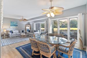 a living room with a glass table and chairs at TP4937: 4937 Turtle Point in Kiawah Island