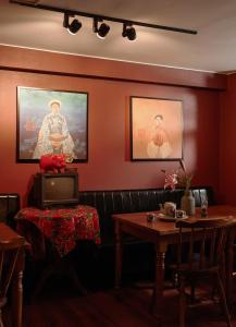a dining room with red walls and two tables at Asian Ruby Hotel & Spa - 122F Bui Thi Xuân Street in Ho Chi Minh City