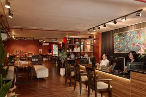two women sitting at a bar in a restaurant at Asian Ruby Hotel & Spa - 122F Bui Thi Xuân Street in Ho Chi Minh City