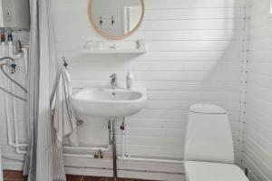 a white bathroom with a sink and a toilet at Cosy Summerhouse With Private Garden in Nyrup +21 photos