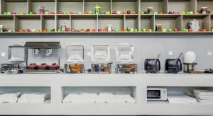 a shelf in a kitchen filled with utensils at VX Hotel Wuhan Optics Valley Yangjia Bay Metro Station in Wuhan +97 photos