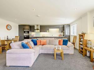 a living room with a couch and a kitchen at 1 Bed in Weymouth 57926 in Osmington