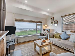 a living room with a couch and a tv at 2 Bed in Bacton 75391 in Bacton