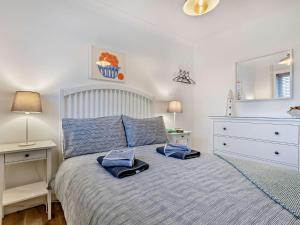a bedroom with a bed with a dresser and a mirror at 2 Bed in Bacton 75391 in Bacton