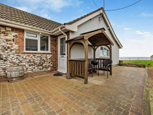 a patio with a gazebo in front of a house at 2 Bed in Bacton 75391 in Bacton