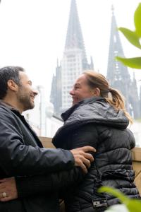 a man and a woman standing next to each other at Hotel Sandmanns am Dom in Cologne