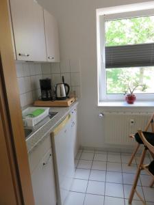 a small kitchen with a sink and a window at Wohnung am Tor zur Lewitz in Banzkow