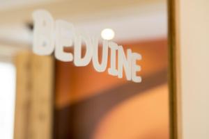 a close up of a sign that says slow cure at Hotel Sandmanns am Dom in Cologne