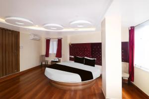 a bedroom with a large bed in a room at Super Townhouse Bank More Dhanbad Formerly Rise And Dine in Dhanbād
