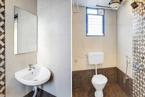 a bathroom with a toilet sink and a mirror at Super Collection O Manjari - Mundhwa Road Formerly 7 Treats in Mundhwa