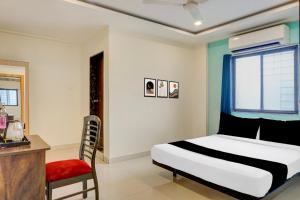 a bedroom with a bed and a chair and a window at Super Collection O Manjari - Mundhwa Road Formerly 7 Treats in Mundhwa +27 photos