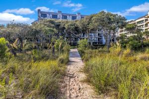 a path through the grass with a building in the background at SW122D: 122D Shipwatch in Isle of Palms