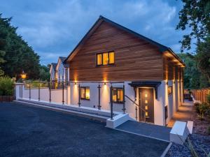 a large wooden house with a lot of windows at 4 Bed in Westward Ho 86640 in Bideford