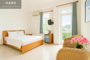 a bedroom with a bed and a chair at S79 Bao Khoi Hotel in Vung Tau
