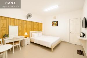 a bedroom with a bed and a desk and a table at S79 Bao Khoi Hotel in Vung Tau