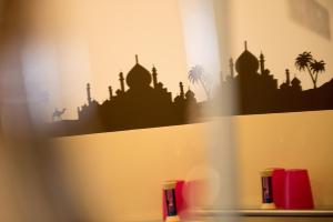 a shelf with a silhouette of a mosque on it at Hotel Sandmanns am Dom in Cologne