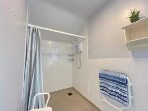 a bathroom with a shower with a blue shower curtain at 4 Bed in Betws y coed 52111 in Capel Garmon +22 photos