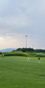a group of people playing frisbee in a field at Heidi Korea in Hongcheon