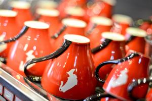 a group of red vases sitting in a row at Hotel Sandmanns am Dom in Cologne
