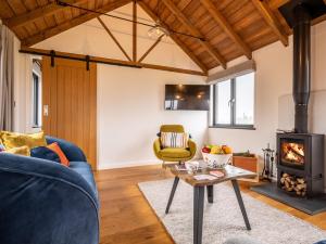 a living room with a blue couch and a wood stove at 2 Bed in Leominster 80510 in Eye