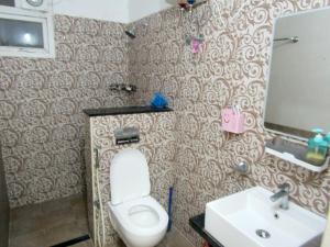 a bathroom with a toilet and a sink at Serenity Homes Near Rushikonda in Visakhapatnam