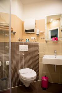a bathroom with a toilet and a sink at Hotel Sandmanns am Dom in Cologne