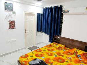 a bedroom with a bed with flowers on it at Serenity Homes Near Rushikonda in Visakhapatnam