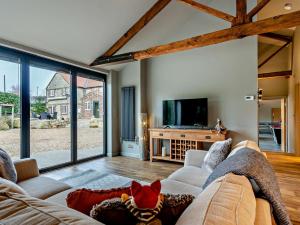 a living room with a couch and a tv at 1 Bed in Leeds 89862 in Sherburn in Elmet