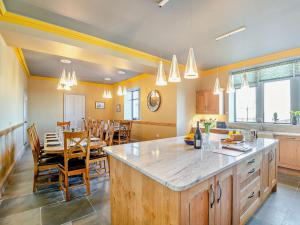 a kitchen with a table and a dining room at 9 Bed in Porthmadog 90740 in Talsarnau