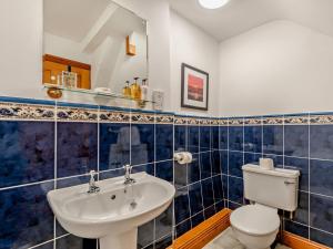 a bathroom with a toilet and a sink at 2 Bed in Bassenthwaite 93463 in Ireby +17 photos