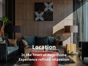 a living room with a couch in the heart of kazakhstan experience retained at Solaria Nishitetsu Hotel Kagoshima in Kagoshima