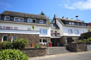 a large white house with stairs in front of it at Hotel Vintage Am Bundesbank-Bunker in Cochem
