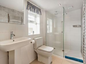a bathroom with a toilet and a sink and a shower at 1 Bed in Elgin 32129 in Burghead +30 photos